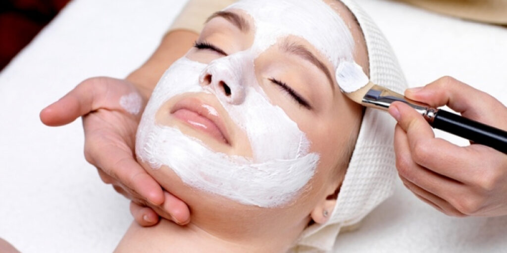 Aesthetic specialist performing a medifacial treatment for deep skin cleansing and hydration at a professional clinic